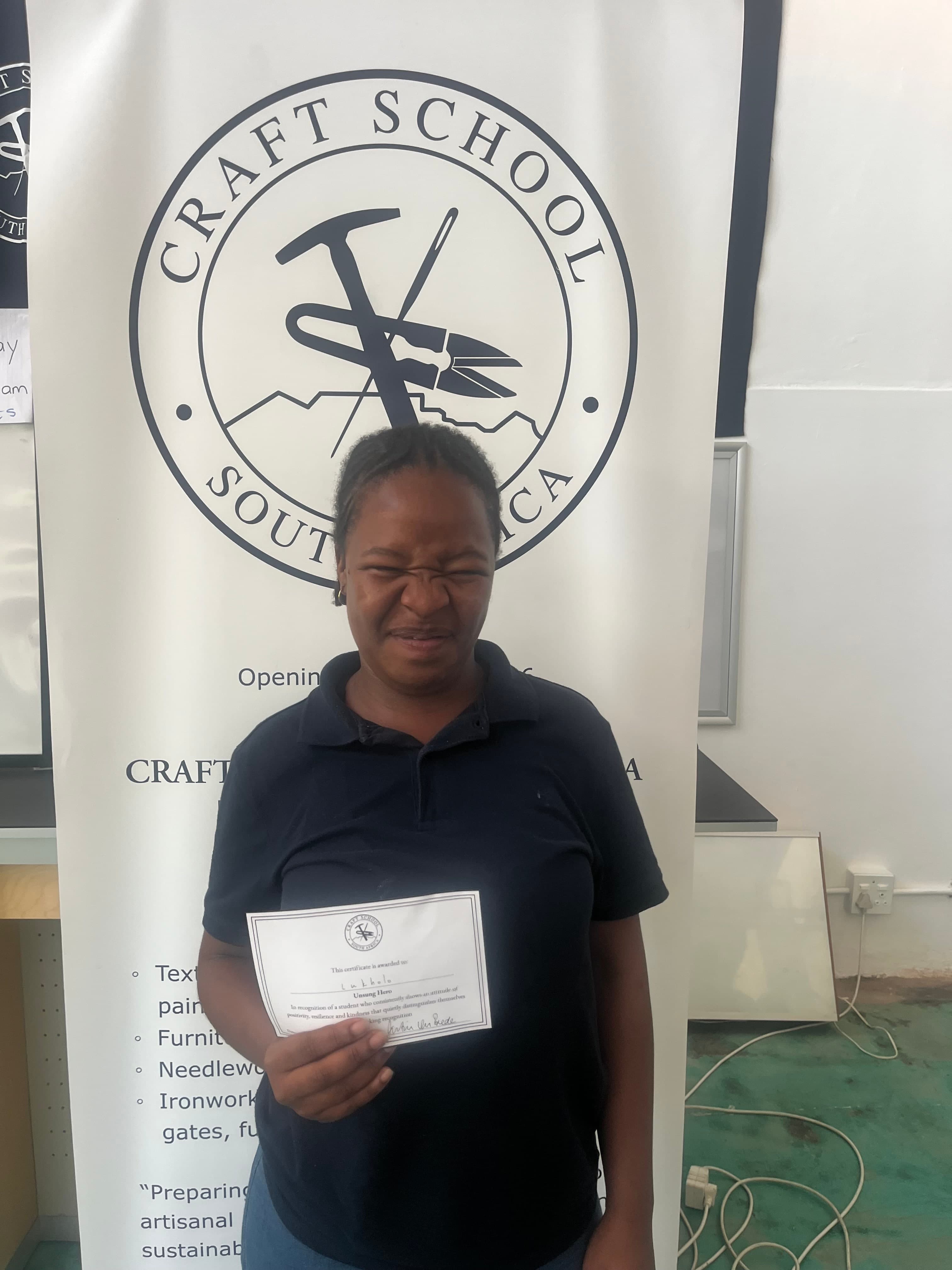 A Craft School student with his Term 1 certificate